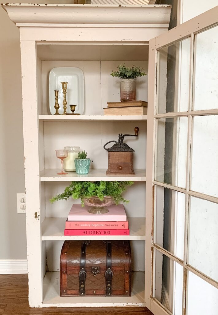 antique cabinet that has been styled by shopping my home for decor items
